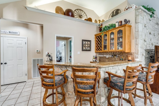 31763 Scarteen, Fair Oaks Ranch, TX 78015 - indoor wet bar with light tile patterned flooring, decorative backsplash, and high vaulted ceiling