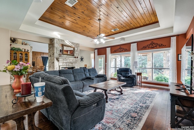 31763 Scarteen, Fair Oaks Ranch, TX 78015 - living area featuring a raised ceiling, hardwood / wood-style floors, wood ceiling, and a stone fireplace