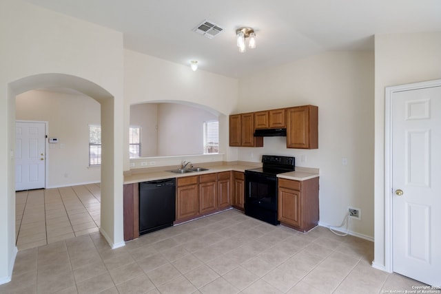 9726 Copper Rock, Converse, TX 78109 - kitchen featuring black appliances, a sink, light tile patterned floors, arched walkways, and under cabinet range hood