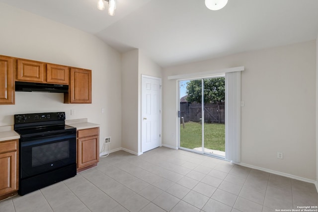 9726 Copper Rock, Converse, TX 78109 - kitchen with black range with electric cooktop, under cabinet range hood, lofted ceiling, light countertops, and brown cabinetry