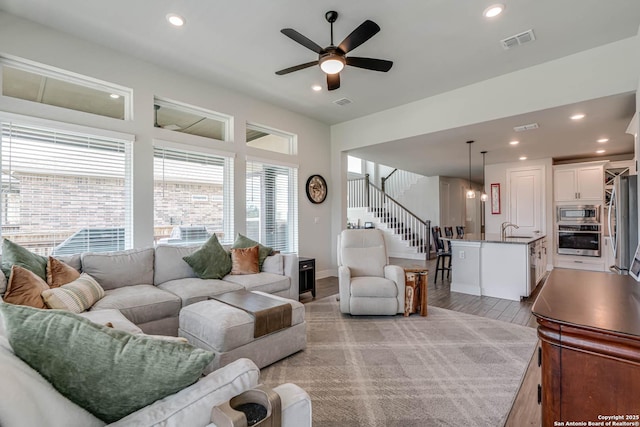 22806 Rio Salado, San Antonio, TX 78261 - living area with stairs, light wood-style floors, ceiling fan, and recessed lighting