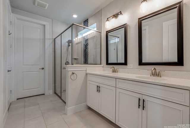 22806 Rio Salado, San Antonio, TX 78261 - bathroom featuring double vanity, tile patterned floors, and a stall shower