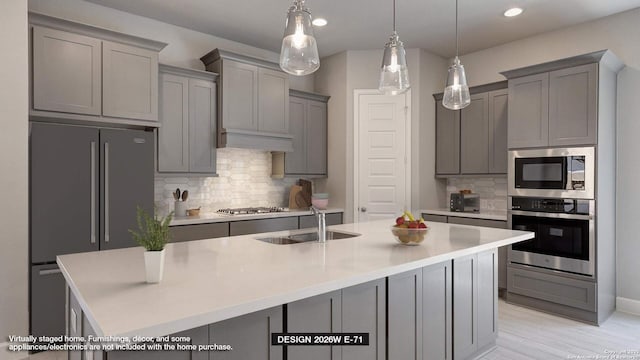 1860 Field Brk, Seguin, TX 78155 - kitchen featuring stainless steel appliances, gray cabinets, a sink, backsplash, and a center island with sink