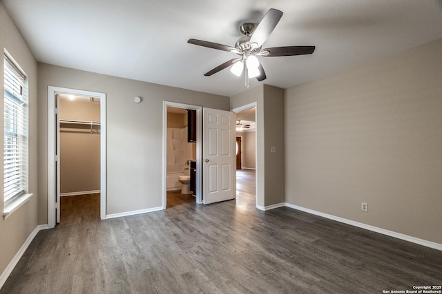 3613 Candleridge, San Antonio, TX 78244 - unfurnished bedroom featuring wood finished floors, a walk in closet, baseboards, and a closet