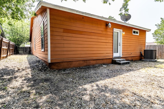 3613 Candleridge, San Antonio, TX 78244 - rear view of house featuring entry steps, central AC, and a fenced backyard