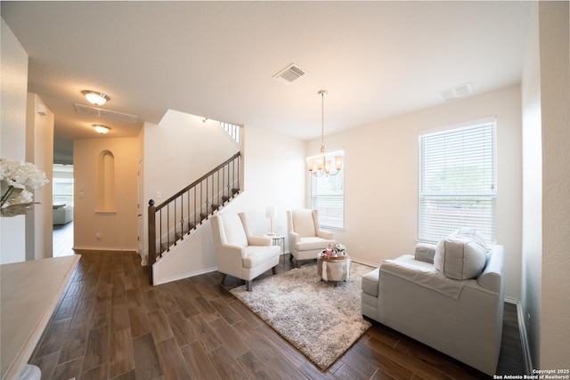 7207 Independence Way, San Antonio, TX 78223 - living room featuring dark wood-style flooring, stairs, a chandelier, and baseboards