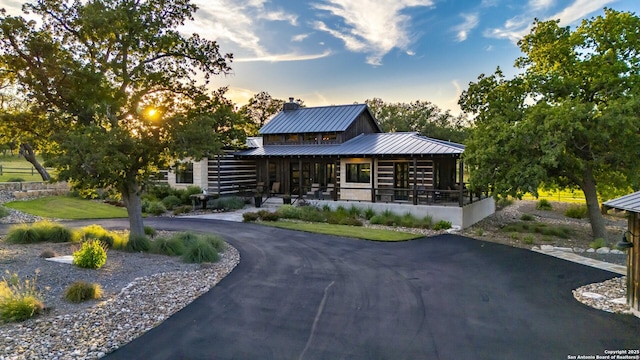 159 Inspiration, Fredericksburg, TX 78624 - log cabin featuring a chimney, metal roof, and curved driveway