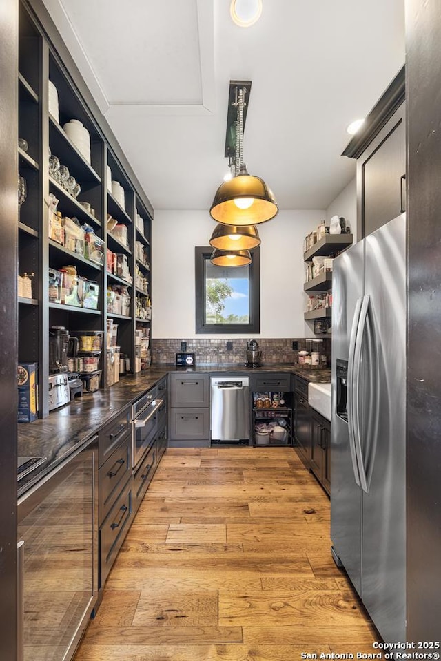 159 Inspiration, Fredericksburg, TX 78624 - kitchen with stainless steel appliances, open shelves, dark countertops, decorative backsplash, and beverage cooler
