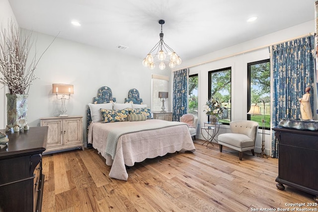 159 Inspiration, Fredericksburg, TX 78624 - bedroom featuring light wood-type flooring, a chandelier, and recessed lighting