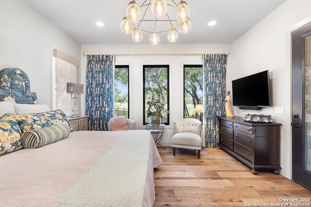 159 Inspiration, Fredericksburg, TX 78624 - bedroom with wood finished floors, multiple windows, a chandelier, and recessed lighting