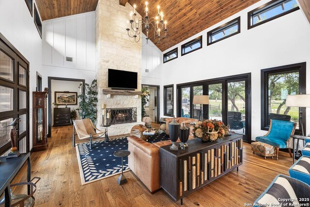159 Inspiration, Fredericksburg, TX 78624 - living room featuring high vaulted ceiling, a fireplace, hardwood / wood-style flooring, wooden ceiling, and healthy amount of natural light