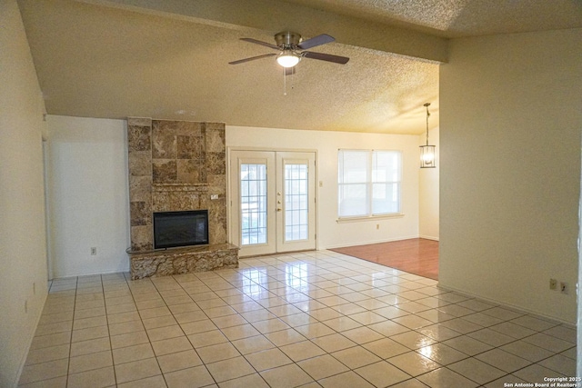 189 Meadowland, Universal City, TX 78148 - unfurnished living room with tile patterned floors, a textured ceiling, a ceiling fan, and a fireplace