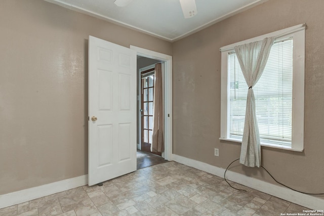 325 Sims, San Antonio, TX 78225 - unfurnished room with baseboards, stone finish floors, ceiling fan, and crown molding