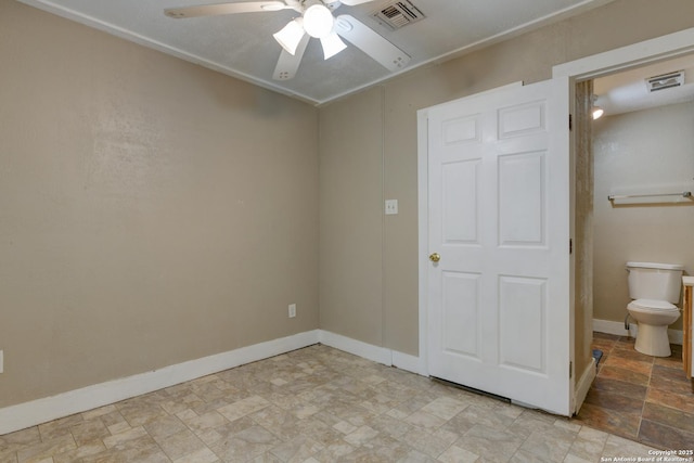 325 Sims, San Antonio, TX 78225 - unfurnished bedroom featuring stone finish floors, baseboards, and ceiling fan