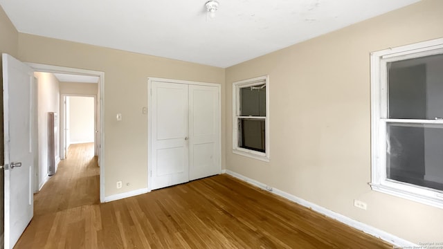 310 Merry Ann, San Antonio, TX 78223 - unfurnished bedroom featuring wood finished floors, baseboards, and a closet