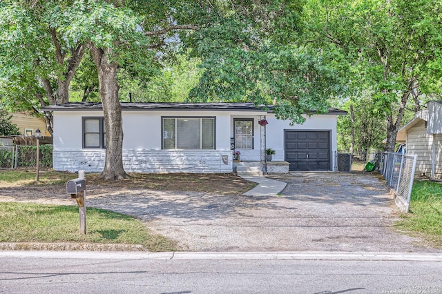 258 S Live Oak, New Braunfels, TX 78130 - ranch-style house featuring asphalt driveway, a garage, stone siding, and stucco siding