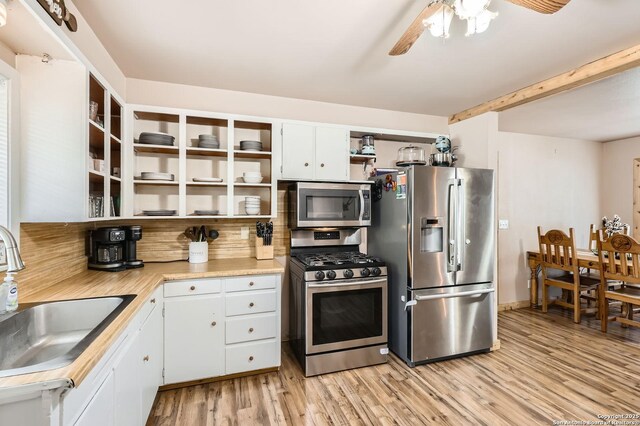 258 S Live Oak, New Braunfels, TX 78130 - kitchen featuring stainless steel appliances, open shelves, a sink, light countertops, and light wood-style floors