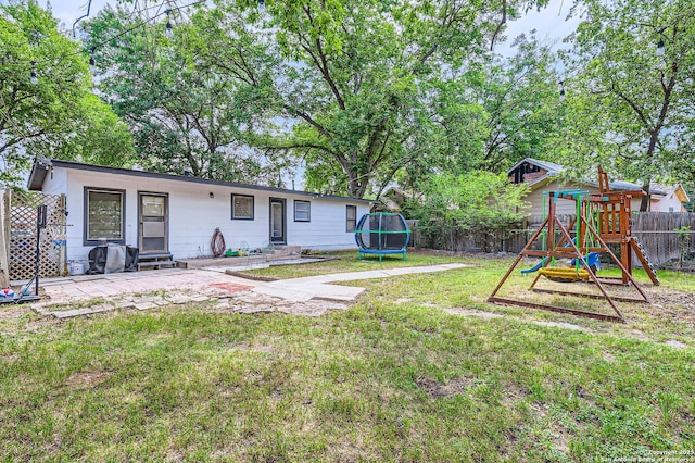 258 S Live Oak, New Braunfels, TX 78130 - view of yard featuring a trampoline, a playground, entry steps, and a patio