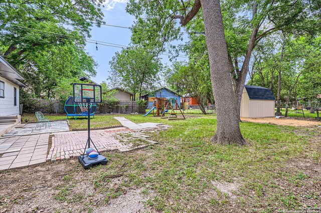 258 S Live Oak, New Braunfels, TX 78130 - view of yard featuring a trampoline, a playground, and a patio area