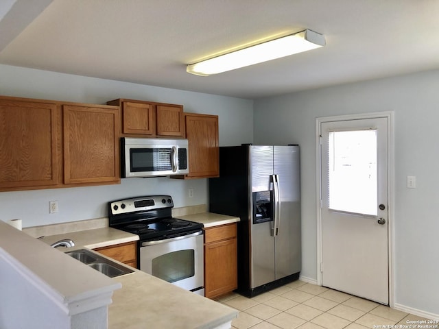 4007 Privet Pl, San Antonio, TX 78259 - kitchen with appliances with stainless steel finishes, brown cabinets, a sink, and light countertops