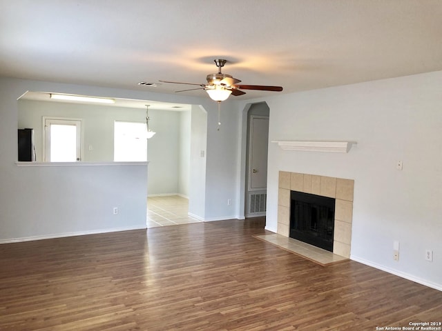 4007 Privet Pl, San Antonio, TX 78259 - unfurnished living room featuring a ceiling fan, wood finished floors, baseboards, and a tile fireplace