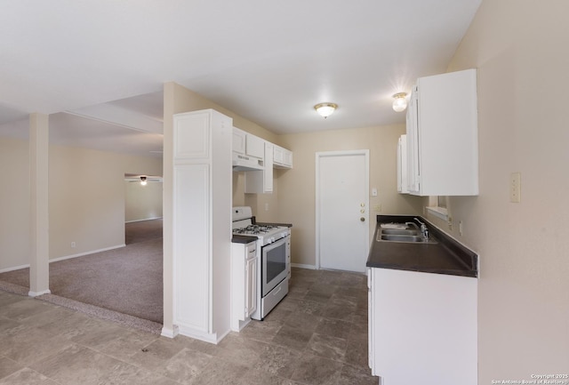 4863 Castle Shield, San Antonio, TX 78218 - kitchen featuring white range with gas cooktop, a sink, white cabinets, and dark countertops