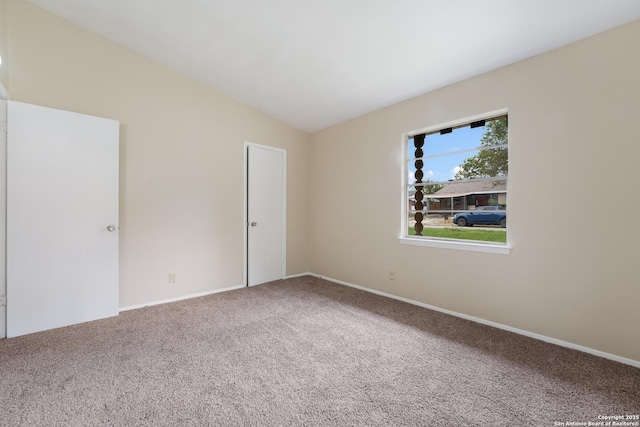 4863 Castle Shield, San Antonio, TX 78218 - empty room featuring carpet floors, vaulted ceiling, and baseboards