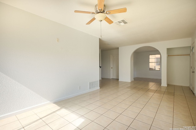 3258 Twining, San Antonio, TX 78211 - spare room with arched walkways, ceiling fan, light tile patterned floors, and baseboards