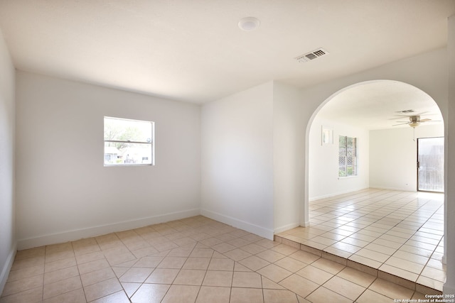 3258 Twining, San Antonio, TX 78211 - spare room featuring arched walkways, light tile patterned floors, ceiling fan, and baseboards