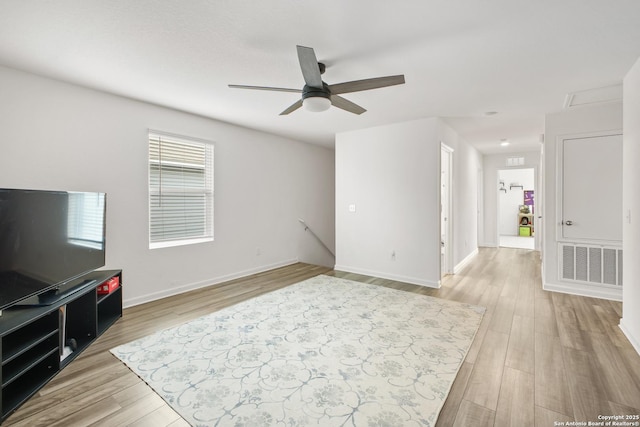 12855 Cygnus, San Antonio, TX 78245 - unfurnished living room with ceiling fan, wood finished floors, and baseboards