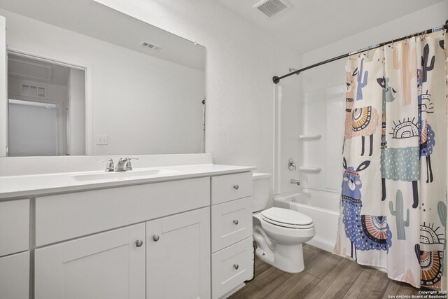 12855 Cygnus, San Antonio, TX 78245 - full bathroom with toilet, vanity, wood finished floors, and shower / bath combo