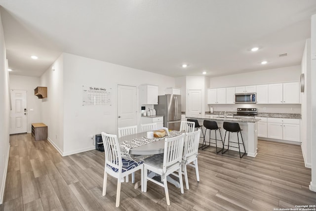 12855 Cygnus, San Antonio, TX 78245 - dining room featuring recessed lighting, light wood finished floors, and baseboards