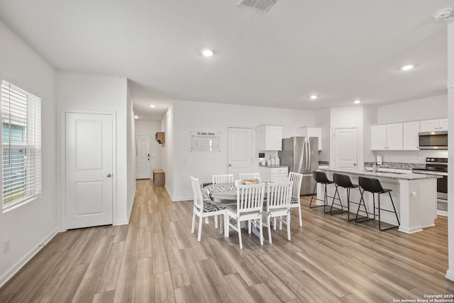 12855 Cygnus, San Antonio, TX 78245 - dining room featuring light wood finished floors, recessed lighting, and baseboards