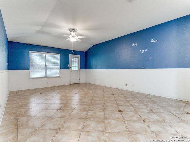 14342 Markham Ln, San Antonio, TX 78247 - spare room featuring wainscoting, ceiling fan, lofted ceiling, and tile patterned flooring