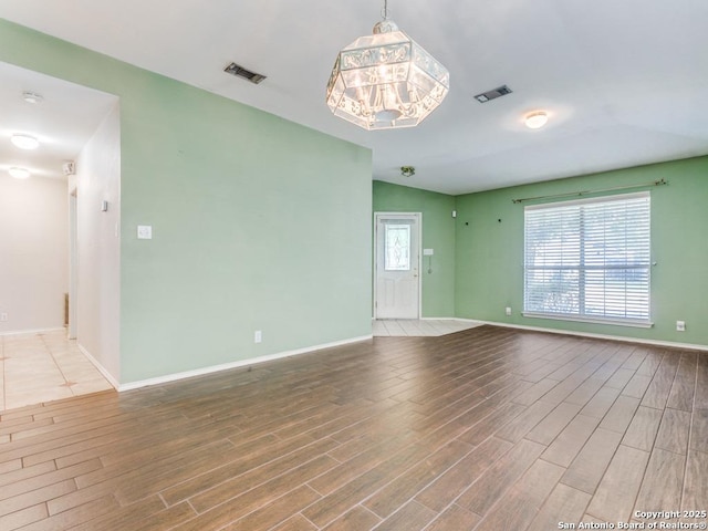 14342 Markham Ln, San Antonio, TX 78247 - spare room featuring wood finished floors, baseboards, and a chandelier