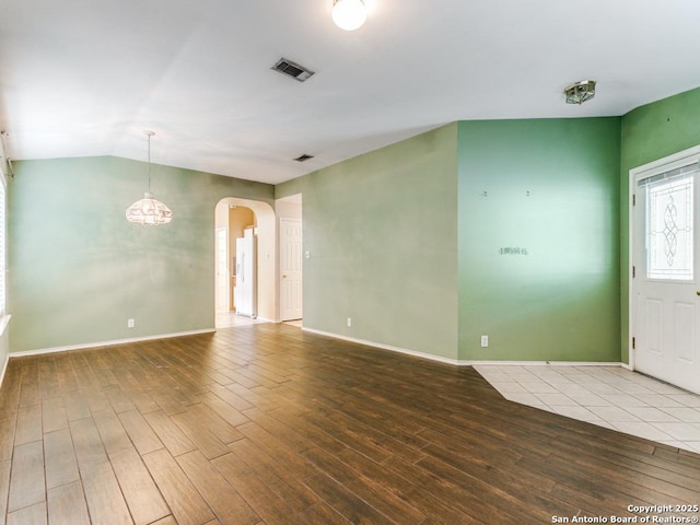14342 Markham Ln, San Antonio, TX 78247 - unfurnished room with wood finished floors, arched walkways, baseboards, and vaulted ceiling