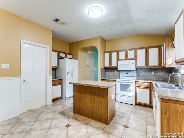 14342 Markham Ln, San Antonio, TX 78247 - kitchen with white appliances, a sink, arched walkways, decorative backsplash, and lofted ceiling