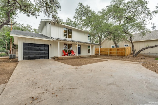 1071 Diamondhead Dr, Canyon Lake, TX 78133 - modern farmhouse style home featuring a garage, concrete driveway, central AC, and board and batten siding
