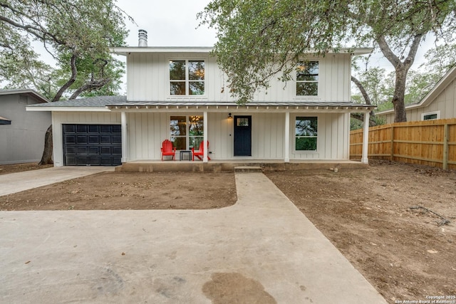 1071 Diamondhead Dr, Canyon Lake, TX 78133 - modern farmhouse style home with a porch, an attached garage, concrete driveway, and board and batten siding