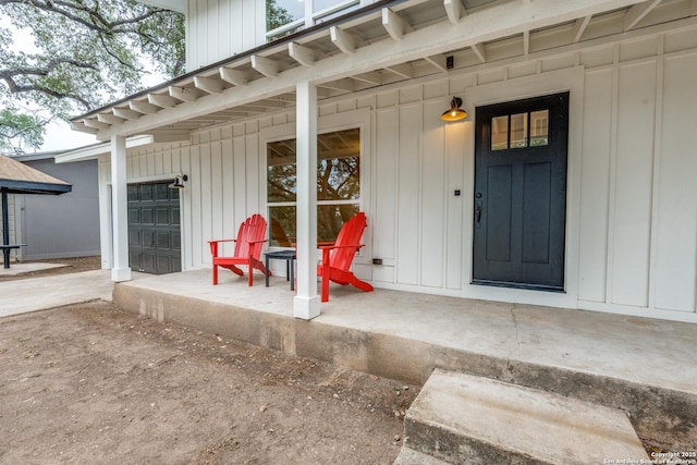 1071 Diamondhead Dr, Canyon Lake, TX 78133 - doorway to property with board and batten siding, a garage, and a porch