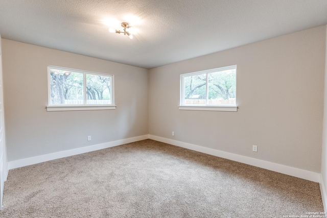 1071 Diamondhead Dr, Canyon Lake, TX 78133 - unfurnished room featuring carpet, baseboards, and a textured ceiling
