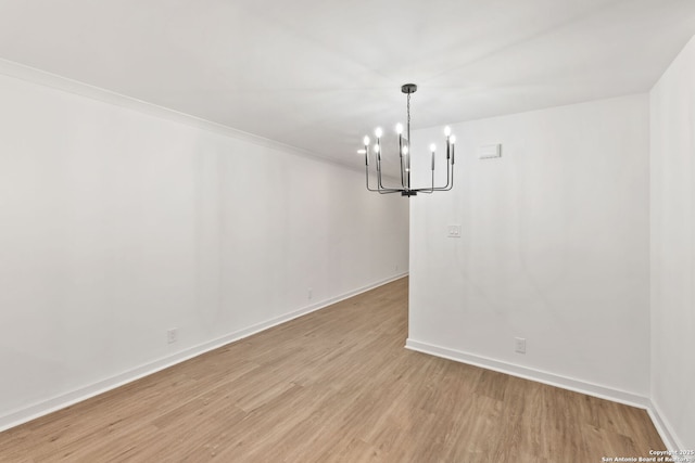 2718 Old Field Dr Unit 101, San Antonio, TX 78247 - spare room featuring a chandelier, light wood-style flooring, and baseboards