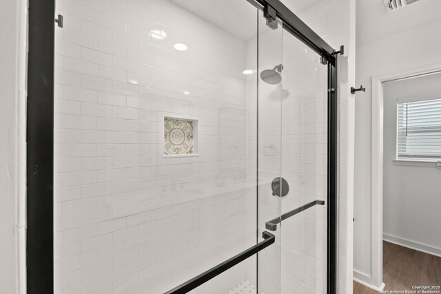 2718 Old Field Dr Unit 101, San Antonio, TX 78247 - bathroom with a shower stall, wood finished floors, and baseboards