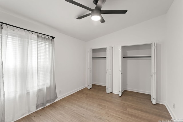 2718 Old Field Dr Unit 101, San Antonio, TX 78247 - unfurnished bedroom featuring multiple closets, lofted ceiling, light wood-type flooring, baseboards, and a ceiling fan