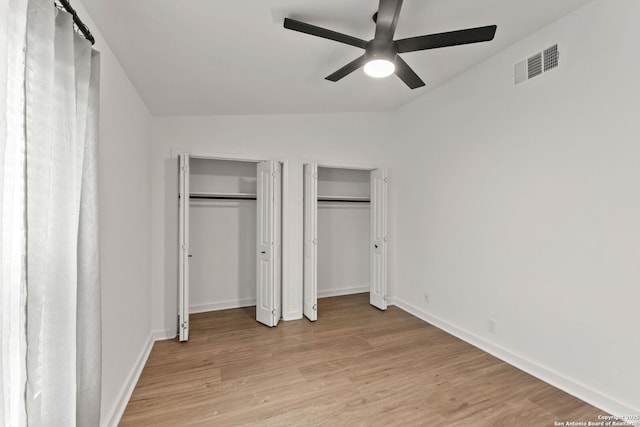 2718 Old Field Dr Unit 101, San Antonio, TX 78247 - unfurnished bedroom with two closets, light wood-style floors, vaulted ceiling, baseboards, and ceiling fan