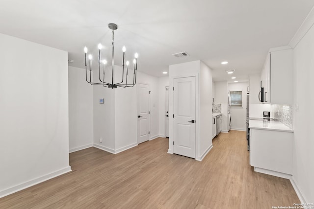 2718 Old Field Dr Unit 101, San Antonio, TX 78247 - unfurnished dining area featuring a chandelier, light wood-style flooring, baseboards, and recessed lighting