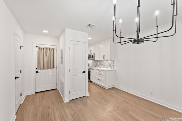 2718 Old Field Dr Unit 101, San Antonio, TX 78247 - entryway featuring light wood finished floors, baseboards, recessed lighting, a chandelier, and electric panel