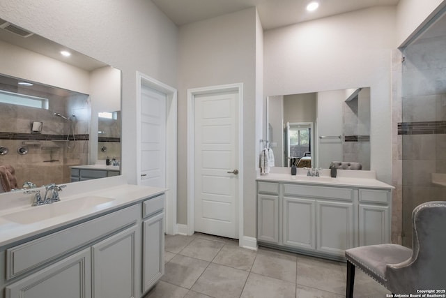 2415 Olive Way, San Antonio, TX 78259 - full bathroom featuring two vanities, a tile shower, and tile patterned flooring
