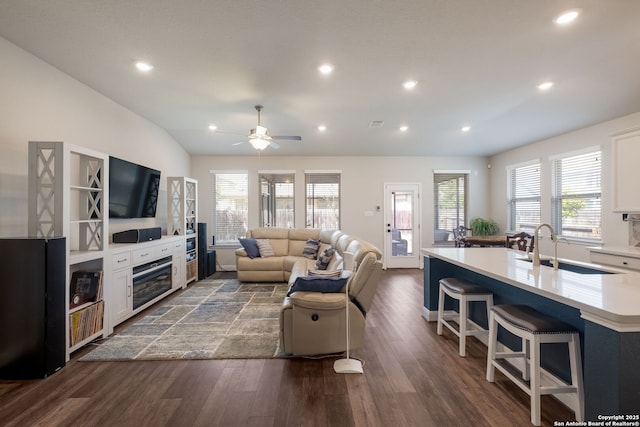 2415 Olive Way, San Antonio, TX 78259 - living area with healthy amount of natural light, dark wood finished floors, recessed lighting, a ceiling fan, and a glass covered fireplace