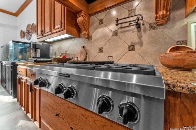 1015 Campanile, San Antonio, TX 78258 - kitchen view of brown cabinetry, backsplash, pot filler, crown molding, and stove